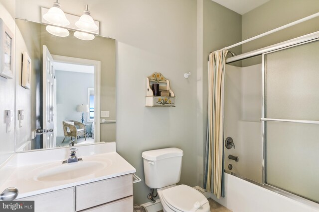 full bathroom featuring toilet, vanity, and enclosed tub / shower combo