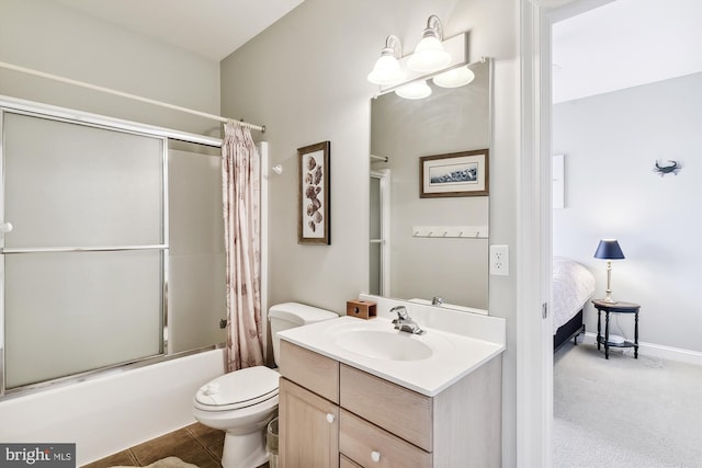 full bath with bathing tub / shower combination, toilet, vanity, ensuite bath, and baseboards