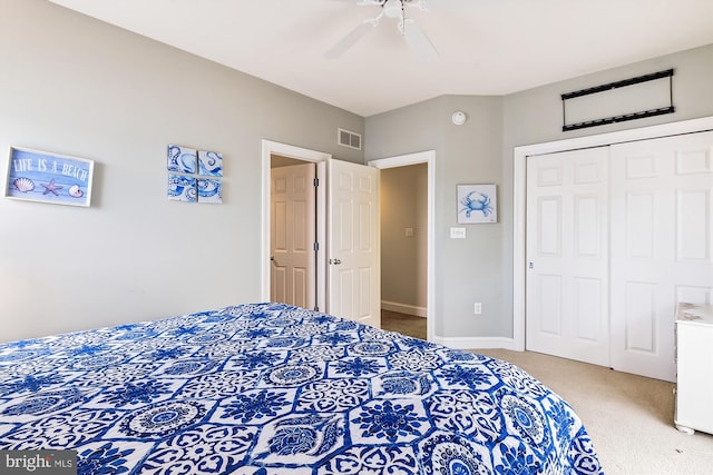 bedroom with a closet, visible vents, light carpet, ceiling fan, and baseboards