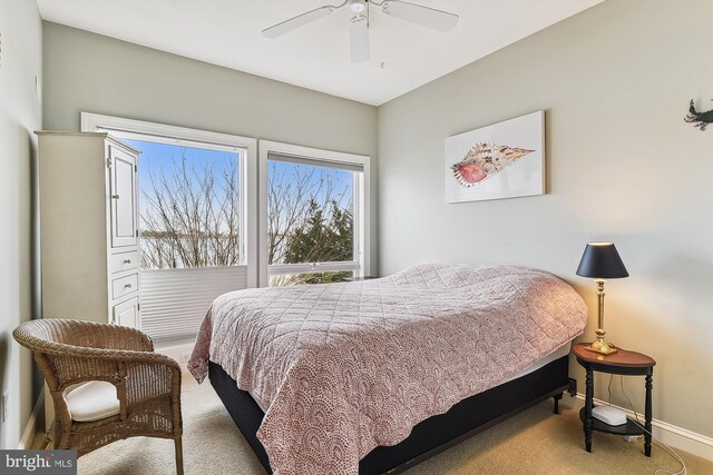 bedroom with ceiling fan and light carpet