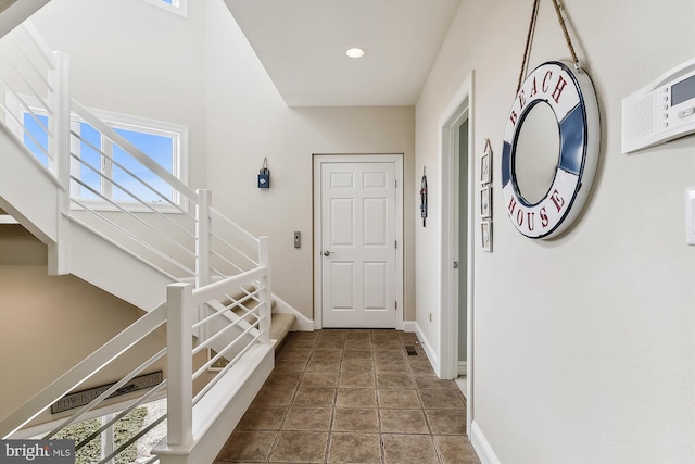 hall with tile patterned flooring, stairs, baseboards, and recessed lighting