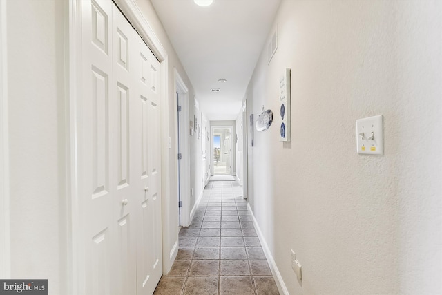 corridor with light tile patterned floors