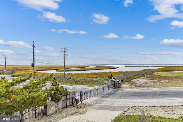 exterior space featuring a gate and a water view