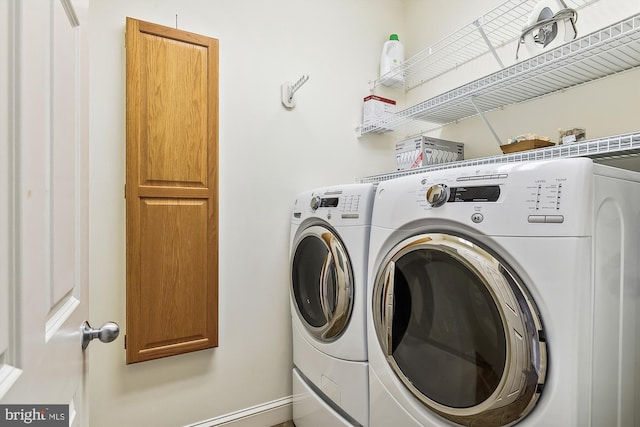 laundry area with cabinet space and washing machine and clothes dryer