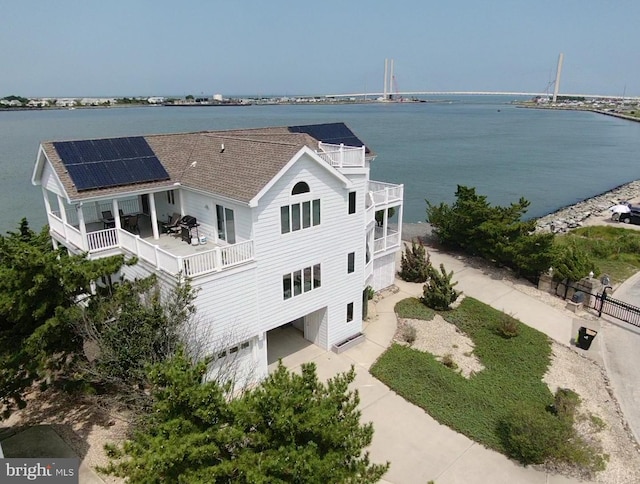 birds eye view of property with a water view