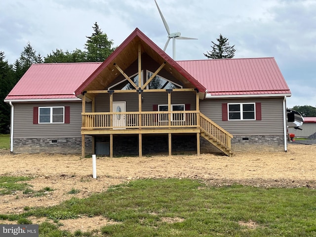 rear view of property with a wooden deck and a yard