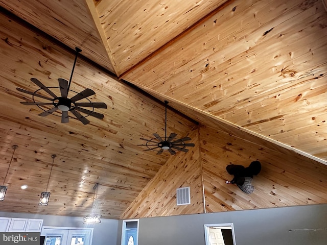 interior details with wood ceiling, wood walls, and ceiling fan