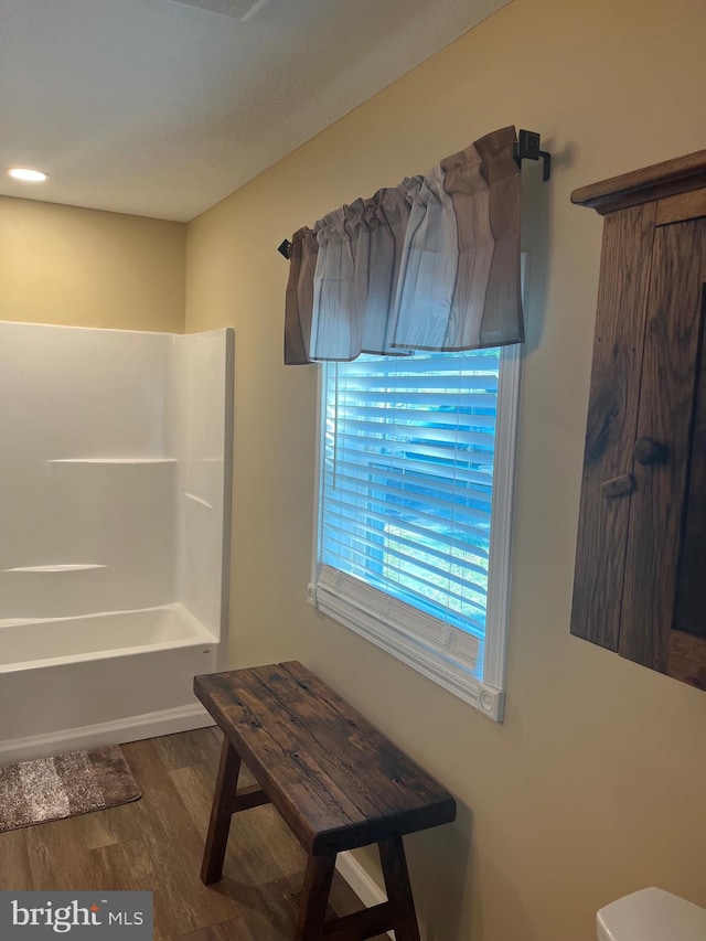 interior space with a shower and hardwood / wood-style flooring