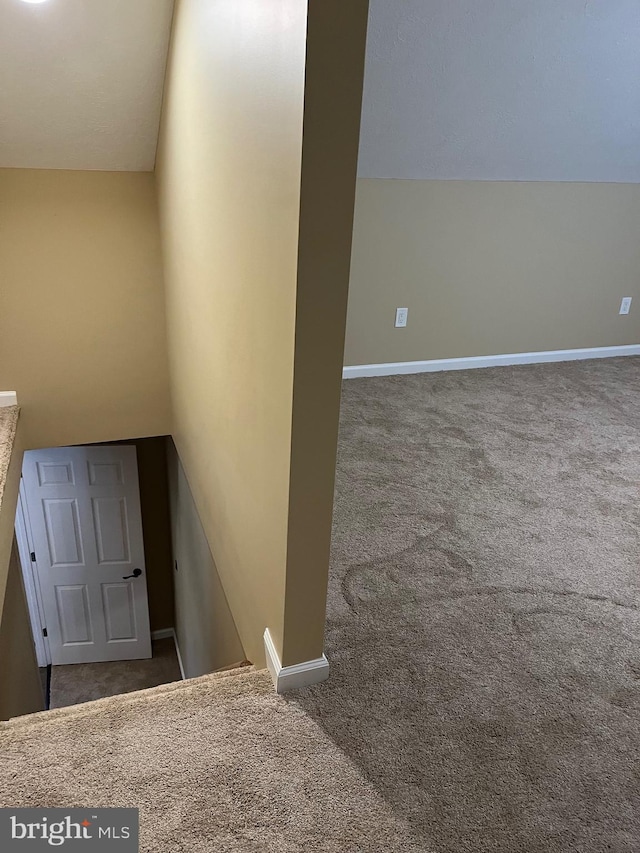 staircase with carpet floors and lofted ceiling