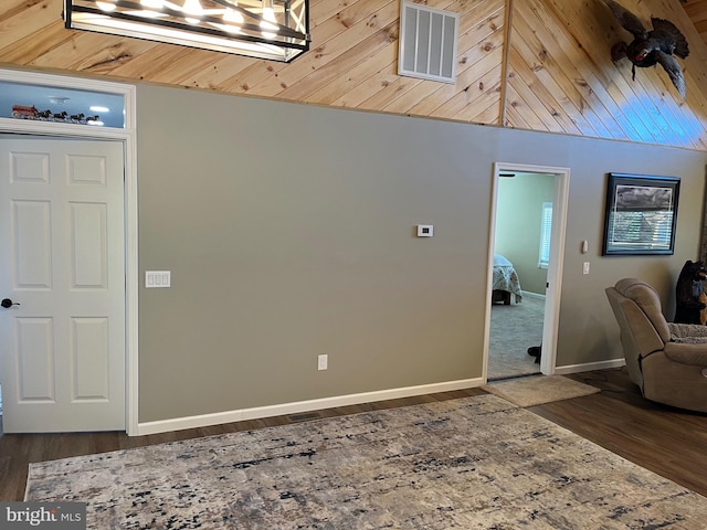 entrance foyer with lofted ceiling and dark hardwood / wood-style floors