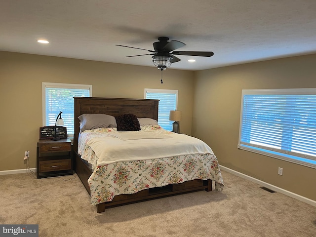 bedroom featuring ceiling fan and light colored carpet