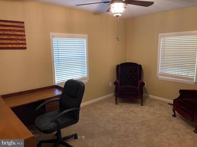 carpeted office featuring ceiling fan