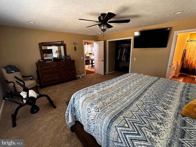 bedroom featuring ceiling fan, a textured ceiling, a closet, and dark colored carpet