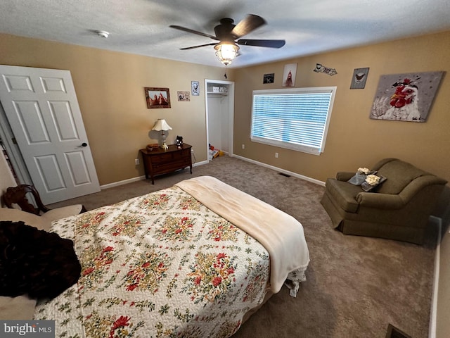 bedroom featuring ceiling fan, carpet floors, and a textured ceiling