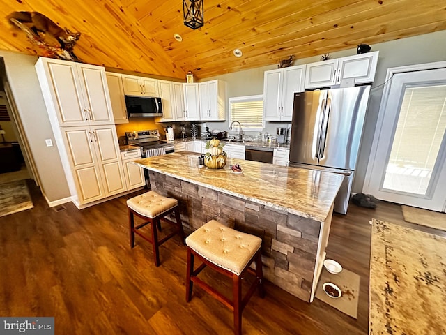 kitchen with wood ceiling, lofted ceiling, stainless steel appliances, dark hardwood / wood-style flooring, and light stone countertops