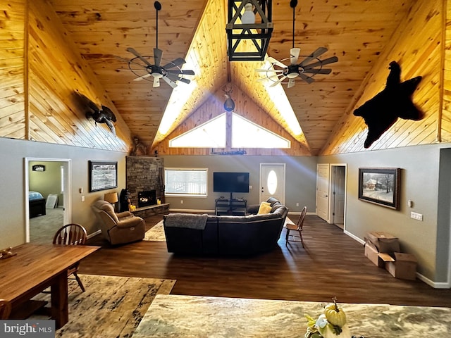 living room featuring ceiling fan, a fireplace, dark hardwood / wood-style flooring, and high vaulted ceiling