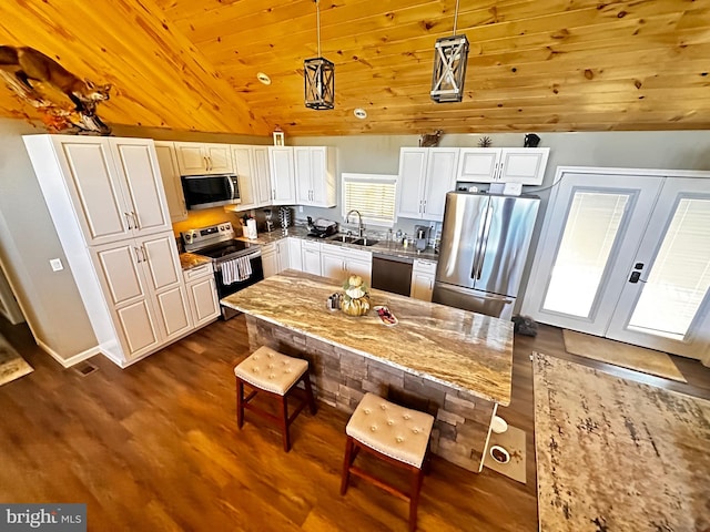 kitchen featuring appliances with stainless steel finishes, light stone countertops, pendant lighting, wooden ceiling, and lofted ceiling