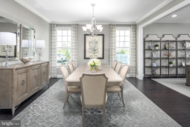 dining space featuring dark hardwood / wood-style flooring, a notable chandelier, ornamental molding, and a healthy amount of sunlight