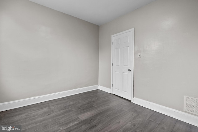 empty room with dark wood-type flooring