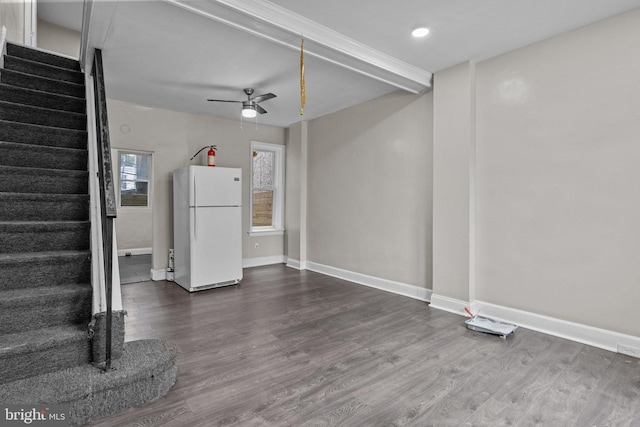 unfurnished living room featuring ceiling fan and hardwood / wood-style floors