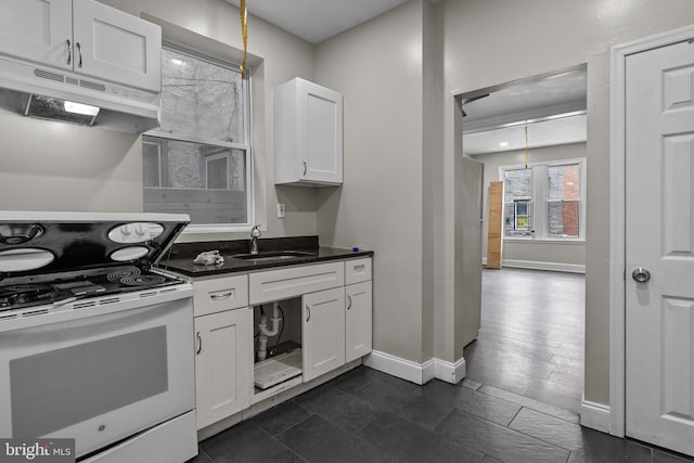 kitchen with decorative light fixtures, sink, white cabinets, dark tile patterned floors, and white electric range oven