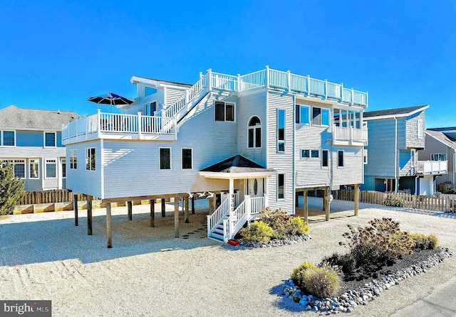 coastal home featuring a carport and a balcony