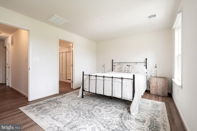 bedroom with dark hardwood / wood-style flooring