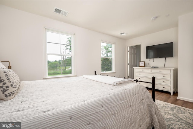 bedroom with dark wood-type flooring