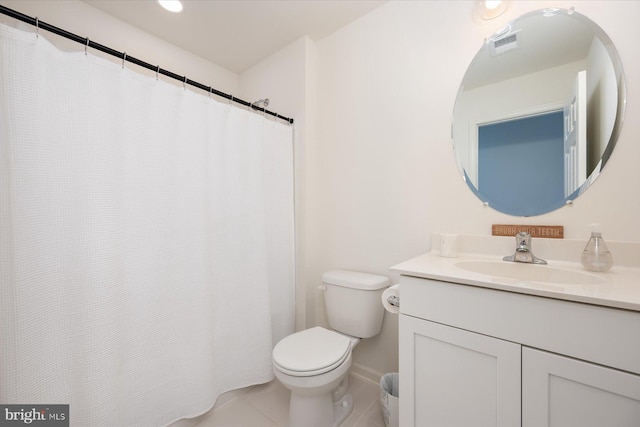 bathroom featuring tile patterned floors, toilet, and vanity