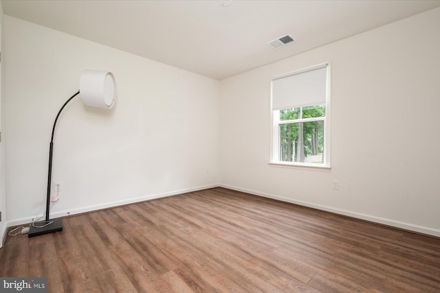 unfurnished room with dark hardwood / wood-style floors