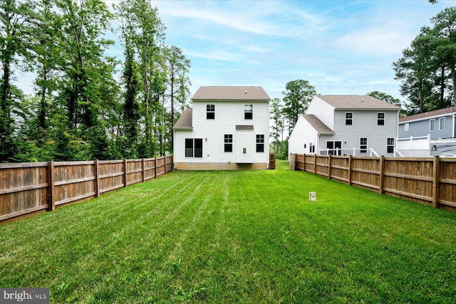 back of property featuring a lawn