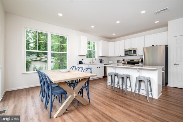 dining room featuring sink and light wood-type flooring