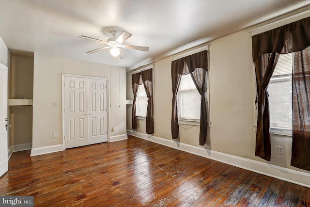 unfurnished room with dark hardwood / wood-style floors and ceiling fan