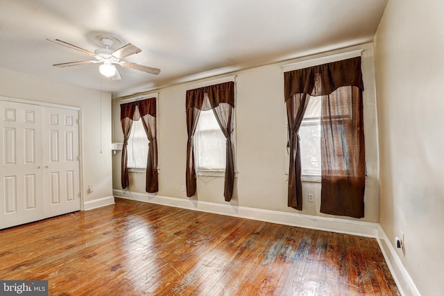 unfurnished room with ceiling fan and wood-type flooring