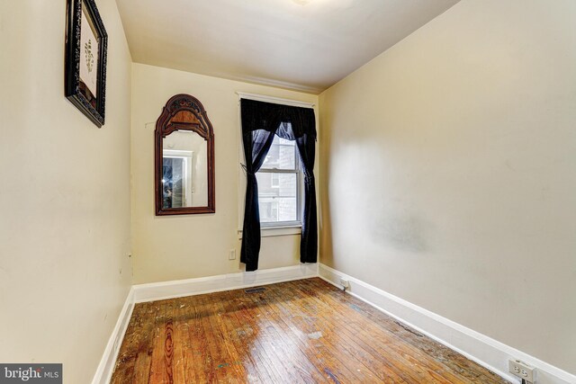 spare room with hardwood / wood-style flooring