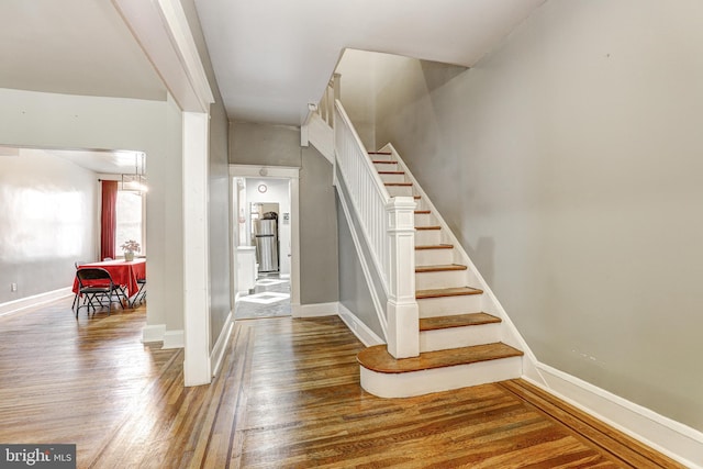 stairway with hardwood / wood-style floors