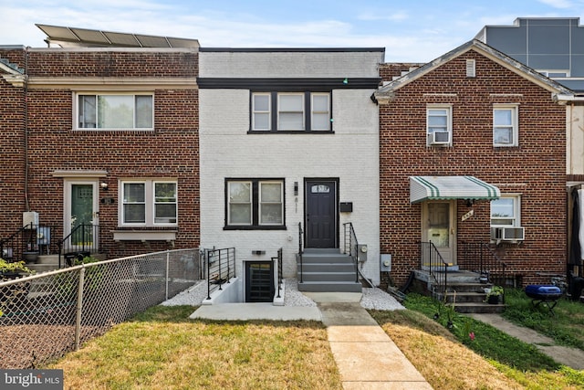 view of property featuring cooling unit and a front yard