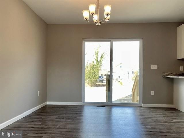 entryway featuring dark hardwood / wood-style flooring and a notable chandelier