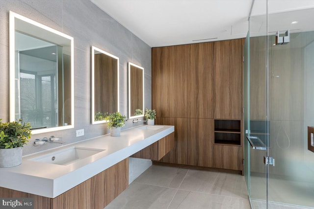 bathroom with walk in shower, tile patterned floors, vanity, and tile walls