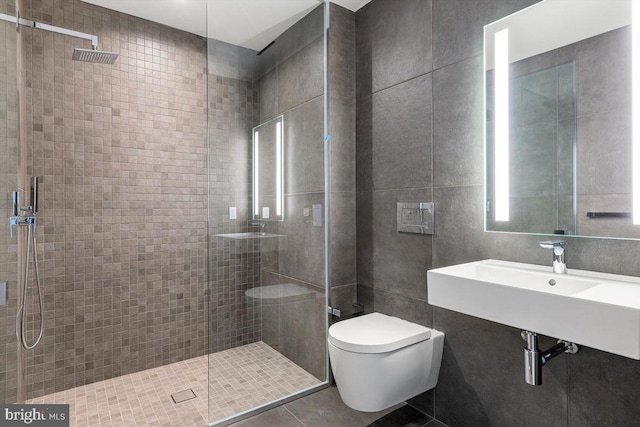 bathroom with toilet, an enclosed shower, and tile walls