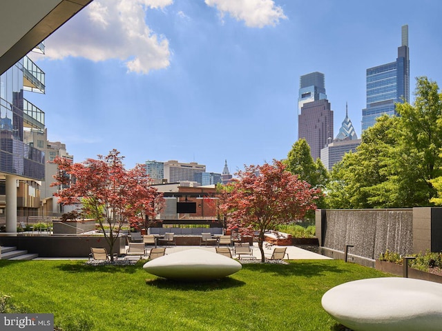 view of community featuring a patio area and a lawn