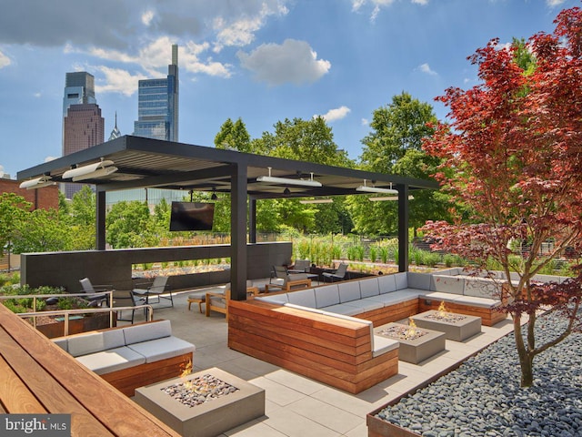 view of patio / terrace with an outdoor living space with a fire pit