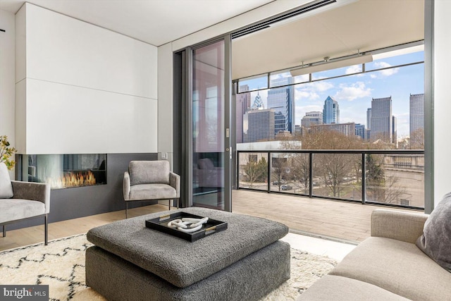 living room with hardwood / wood-style flooring and floor to ceiling windows