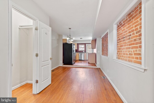 unfurnished bedroom featuring hardwood / wood-style floors, a closet, and ceiling fan