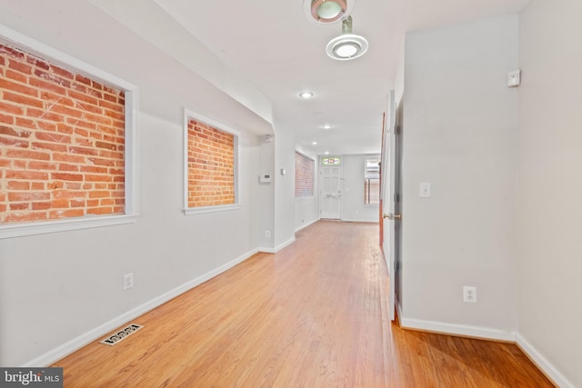 corridor with light wood-type flooring