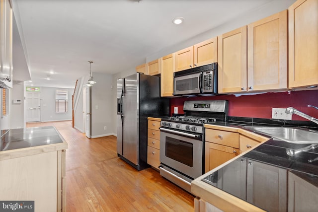 kitchen featuring sink, light brown cabinets, and appliances with stainless steel finishes