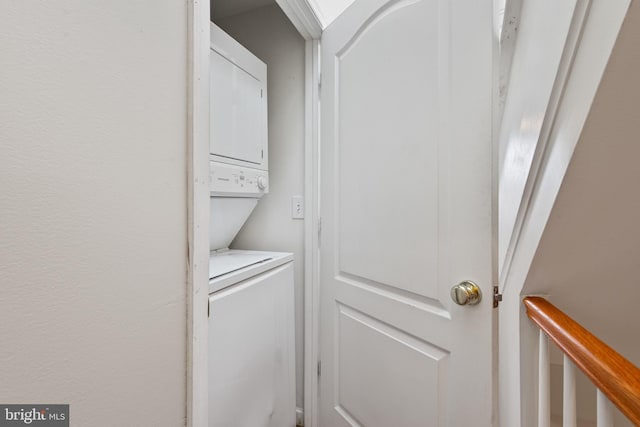 washroom featuring stacked washer / dryer