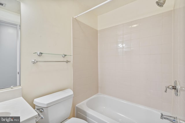 full bathroom with vanity, tiled shower / bath, and toilet