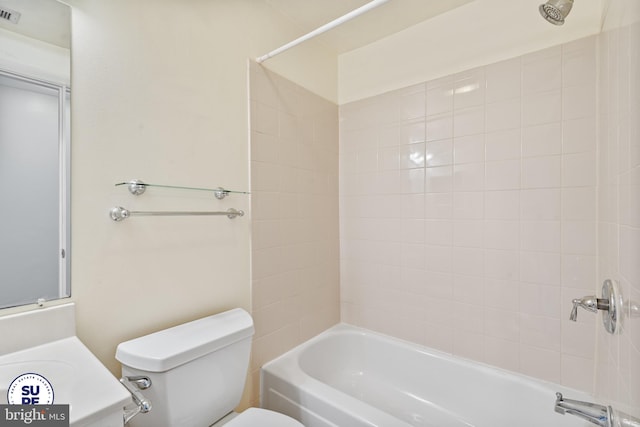 bathroom with tiled shower / bath combo and toilet