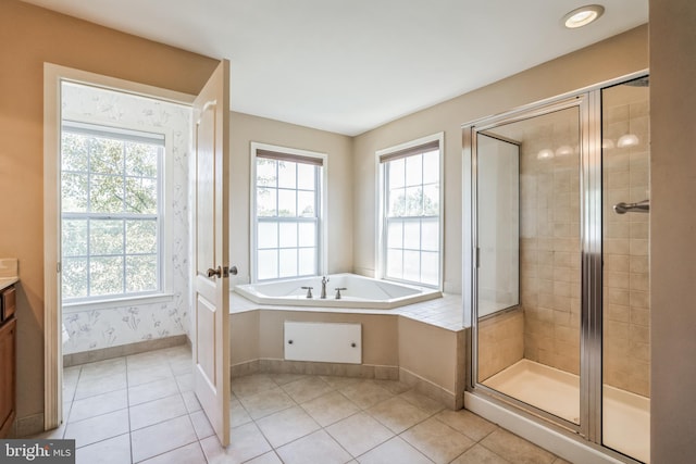 bathroom featuring tile patterned flooring, shower with separate bathtub, a healthy amount of sunlight, and vanity